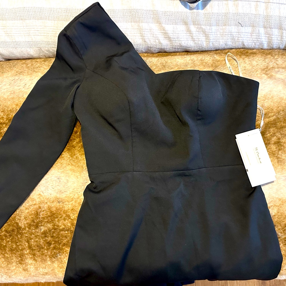 Off the shoulder, one sleeve, long black dress.
